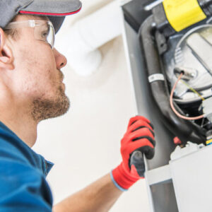 Technician checking furnace for problems