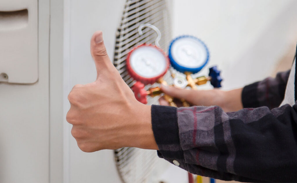 Technician is checking air conditioner, measuring equipment for filling air conditioners.Total Comfort Benefits of Regular Furnace Service